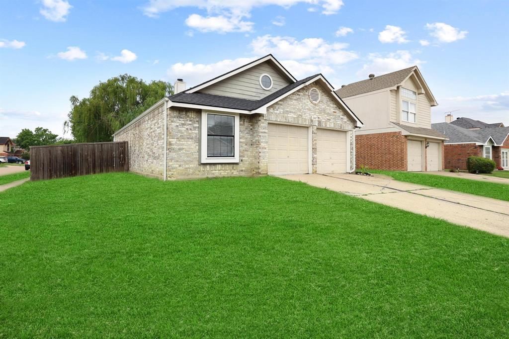 Welcome to this spacious and light filled 3 bedroom 2 bath home situated on a desirable corner lot in the established Indian Oaks neighborhood of Lewisville. From the moment you step inside, you will appreciate the tall vaulted ceilings, abundant natural light, and open floor plan designed for comfortable everyday living and entertaining. The expansive living room features rich wood look vynl plank flooring, a cozy wood burning fireplace, and large windows that create an inviting atmosphere throughout the home. The kitchen overlooks the main living area and offers ample cabinet and countertop space, a breakfast bar, pantry, and an easy flow into the dining area. A separate flex room with French doors provides endless possibilities as a home office, formal dining room, playroom, hobby room, or third bedroom. The private primary suite offers vaulted ceilings, generous floor space, backyard access, a large closet, dual sinks, and plenty of room to unwind at the end of the day. The additional bedroom and a second full bath provide flexibility for family, guests, or work from home needs. Outside, enjoy a patio overlooking a spacious fenced backyard shaded by a mature tree, creating the perfect setting for outdoor entertaining, gardening, pets, or play. The attached two car garage and dedicated utility room add convenience and functionality. Located within Lewisville ISD and close to shopping, dining, parks, entertainment, and major commuter routes, this home offers an exceptional opportunity for buyers seeking space, value, and potential in a highly desirable location. With its open layout, vaulted ceilings, versatile living spaces, and large backyard, this property is ready for its next owner to make it their own. Whether you are a first time buyer, investor, or someone looking to downsize without sacrificing comfort and outdoor space, this home delivers a combination of affordability, functionality, and location that is increasingly difficult to find in Lewisville.
