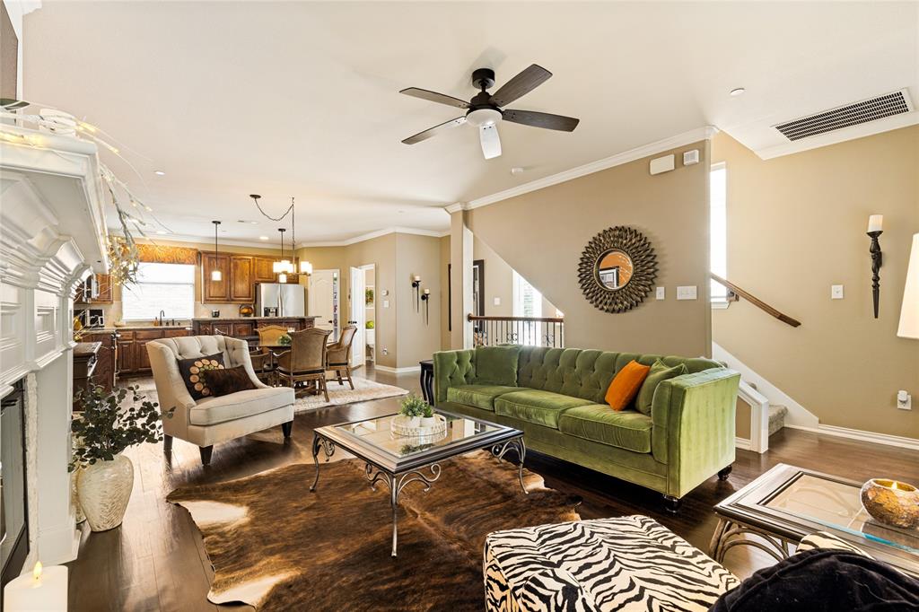 This sophisticated three-story townhome in the highly sought-after Brownstones at Vista Ridge offers the perfect blend of designer elegance and effortless, low-maintenance living. As a coveted end unit, this home is bathed in natural light, creating a bright and airy atmosphere that sets it apart from the rest.

Home Highlights with Designer Touches: This residence is filled with custom decor features throughout, giving it a unique, high-end feel.

Sophisticated Master Retreat: Located on the third floor for maximum privacy, the primary suite features wood beamed ceiling detail, a stunning faux fireplace, creating a cozy and luxurious ambiance. It is complemented by a spa-like ensuite with dual sinks, a jetted tub, a separate shower, and a large walk-in closet.

Open-Concept Living: The second floor serves as the heart of the home, featuring rich flooring, crown molding, and an expansive living area. The chef’s kitchen boasts granite countertops, a large island, and a walk-in pantry, all flowing seamlessly into the dining area.

Flexible Layout: The first floor offers a private guest suite or home office with its own ensuite bathroom—perfect for guests or a quiet workspace.

Premium Convenience: Situated in a prime location within the community, this unit is just steps away from the mail station. It features a large two-car garage plus ample nearby visitor parking, a rare find in townhome living.

Community & Lifestyle:
Enjoy a true lock-and-leave lifestyle with an HOA that covers exterior maintenance, lawn care, water, and trash. You are minutes away from major shopping at Costco and Target, a variety of dining options, and quick access to I-35 and Highway 121 for an easy commute to DFW Airport or Dallas.