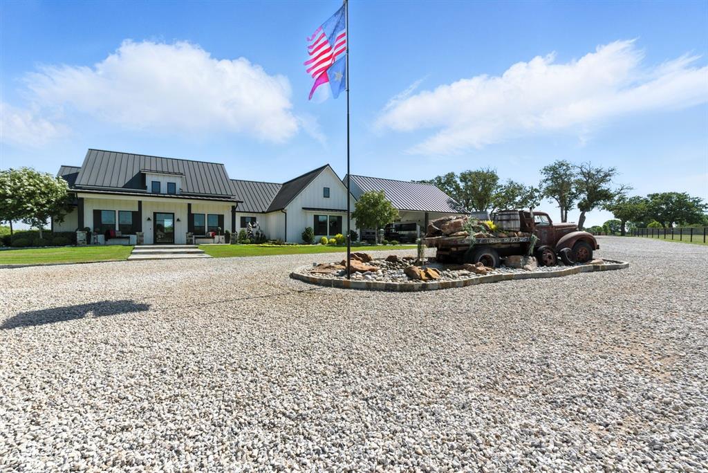 Welcome to an exceptional premier horse property where luxury meets equine excellence. Nestled on expansive, manicured acreage, this custom-built farmhouse offers timeless charm and modern comfort, designed with thoughtful detail for both owners and equine companions. The main home exudes farmhouse elegance with spacious living areas and serene views of the ranch. Horse lovers will appreciate the oversized barn featuring oversized stalls, each equipped with automatic waterers, and an attached 1,200 sq ft studio apartment—perfect for guests, trainers, or short-term rental potential. The property includes a lighted outdoor arena,, along with a professional-grade aquatred system to support equine conditioning and rehabilitation. Multiple turnout pastures, ample covered parking, worker quarters, and carefully planned infrastructure make this a fully functional and income-producing horse facility. Whether you're a professional trainer, breeder, or simply seeking a luxury equestrian lifestyle, this ranch has it all—function, beauty, and opportunity. A rare offering for serious horsemen—schedule your private tour today.