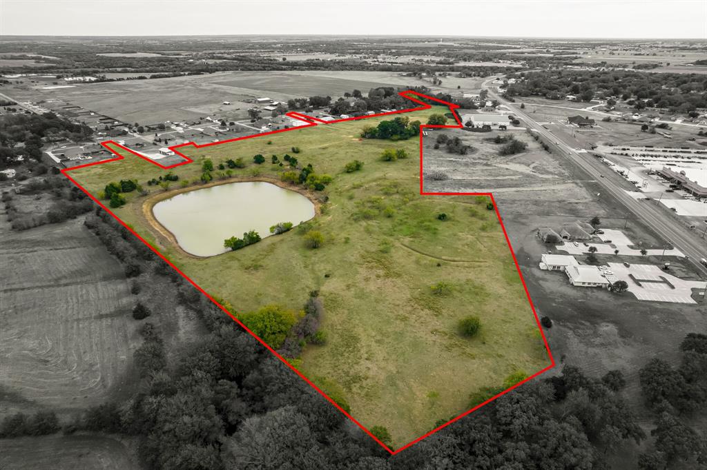 Come see this scenic property in the heart of Whitesboro.  Ready for development.  This property DOES NOT front hwy 377.  Access is off of Bois D'Arc St.  There are three possible ways to access this land off of Bois D'Arc St.    This is 33.455 acres of R-1 zoned land in the city limits of Whitesboro.  The city of Whitesboro has confirmed there are city utilities available to service this area.  Beautiful pasture land with some mature trees and a large pond.  The remains of the old house are still present.  DO NOT try to access the remains of the old house.  It is dangerous.  There is an old well near the old house.  It is uncovered.  Use caution.  This property is in the Whitesboro city limits.  It is zoned residential.  Any development will need to coordinate with the city of Whitesboro regarding restrictions or requirements.
New Survey is completed - contact listing agent for survey.  Final survey is completed and provided in the mls docs.