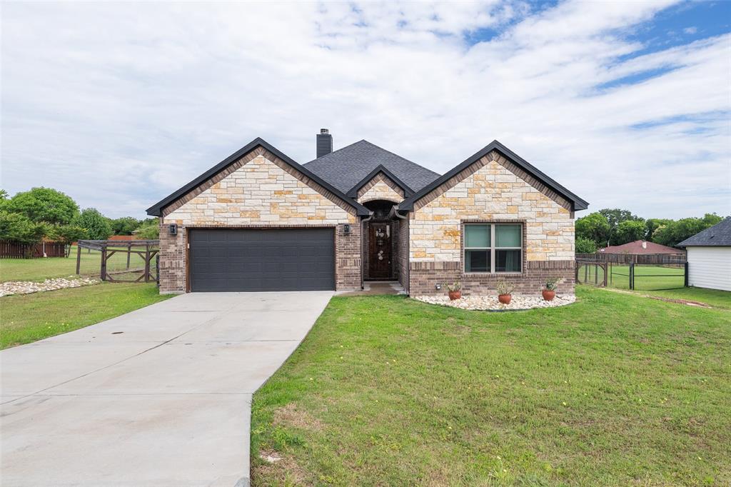 **Motivated Seller!** Welcome home to a space that feels both calming and intentional.  Constructed in 2021, the layout of this 1,886 square foot home was created to retreat from the outside to have the feeling of comfort.  From the moment you walk in, you are greeted with natural light, rich flooring, and an open, airy layout designed for connection.  Whether you are enjoying a quiet morning coffee in the breakfast nook, hosting friends and family around the large kitchen island, or winding down in front the fire after a long day, this home offers a relaxed lifestyle with modern touches throughout.  Living area features large windows across the back of the home and a wood-burning fireplace featuring Texas limestone.  The kitchen is the focal point with a granite island that centers the space.  Upper and lower cabinets with a walk-in pantry provides plenty of storage.  Eating area is a space that can be as flexbile as you need it to be:  keep it as an eating area, make it into an office space, or whatever your family needs it to be.  Master suite is located off the living area overlooking the backyard.  Walking into the bathroom gives you a feel of a space of tranqulity with separate tub and shower, walk-in closet, double vanity sink, extra storage, and unique style.  Additional two bedrooms are located in the front of the home both with spacious closets with a bathroom in between.  Situated on approximately half an acre, the spacious backyard provides endless possiblities for outdoor entertaining, building a garden, or adding a swing set.  HOA allows for construction of additional spaces like separate garage, shed, or whatever you design.  Indian Harbor community has a pool, marina, volunteer fire department, and other features for its members.  Enjoy being close to Granbury while not having to pay city taxes - property is located in county taxing only.  Come see the unique touches of this home built for comfort and connection.