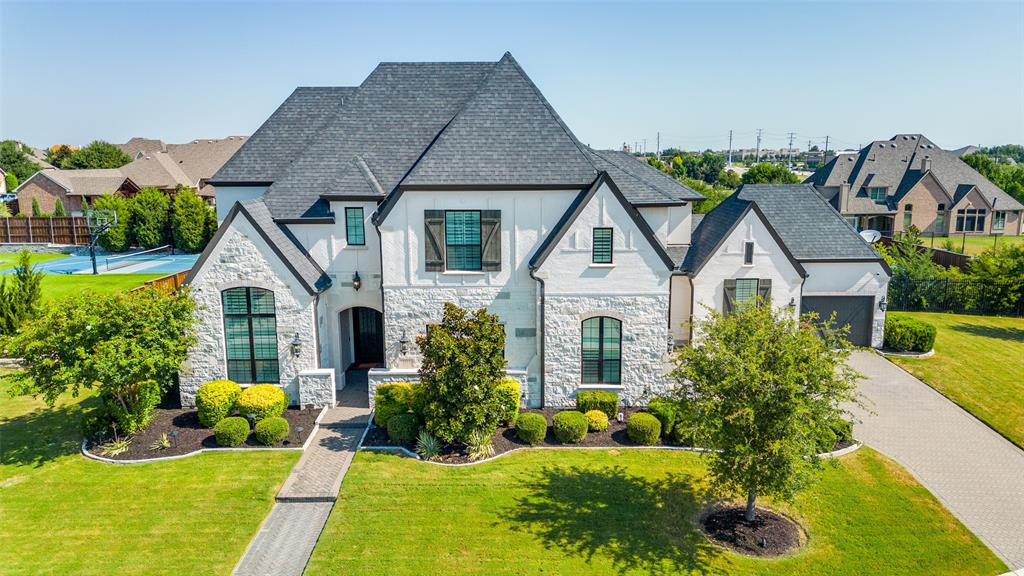 Stunning Huntington home on one of the most beautiful lots in Parkside, sides to greenbelt and backing to trees on approximately half-acre. The resort-style pool features a waterfall and firepit. Home has a separate pavilion featuring Green Egg, outdoor kitchen with sink, and two refrigerators, plus a large covered veranda and pickleball court. Highly desired design with impeccable finish out. The Chef inspired kitchen, with high end appliances opens to a spacious family room with a fireplace, rich wood-beamed ceiling, and wall of windows The large master suite with sitting area, & deluxe bath, his & her vanities & custom closet. A downstairs guest bedroom serves as an in-law suite with its own kitchen, private bath, and separate entrance. The stately study has a wall of built-ins & French doors. Upstairs features a game room, three bedrooms with en-suites, and a study area await. Highlights include hardwood floors, abundant storage, and custom built-ins.