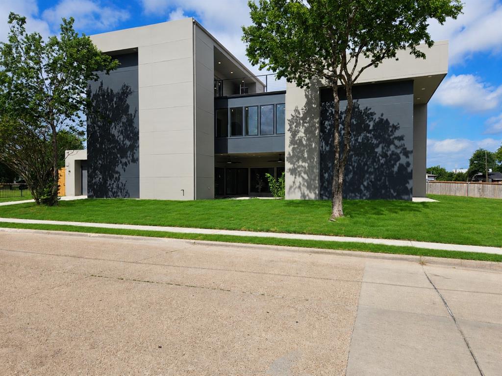 Architectural sophistication meets modern luxury in this exceptional contemporary residence, perfectly positioned on a premier corner lot in the heart of Trinity Groves, one of Dallas fastest growing and most sought after neighborhoods. Just minutes from Downtown Dallas, the Design District, Bishop Arts, and premier dining and entertainment, this home offers the ultimate urban lifestyle. Offering approximately 3,200 square feet, this stunning three story home features 4 bedrooms, 3.5 bathrooms, a versatile third floor flex room with a wet bar, and a 2 car garage. Step inside to soaring ceilings, dramatic two story living spaces, walls of glass, and an abundance of natural light surrounding a tranquil interior courtyard. The open concept layout is ideal for both everyday living and entertaining. The chef's kitchen showcases custom flat panel cabinetry, premium stainless steel appliances, designer lighting, and an oversized waterfall island. An elevated dining area overlooks the main living space, further enhancing the home's striking architectural appeal. The luxurious primary suite features a sleek linear fireplace, private courtyard access, and a spa inspired ensuite complete with dual rain shower heads, a freestanding soaking tub, dual vessel vanities, and an expansive walk in closet with custom built in shelving. The spacious third floor area features a wet bar and fireplace, creating the perfect setting for entertaining, relaxing, or hosting guests. Enjoy a covered patio, private backyard, and beautifully landscaped courtyard, offering multiple outdoor spaces to unwind year round. The crown jewel of the home is the expansive rooftop deck, showcasing breathtaking Downtown Dallas skyline views and unforgettable Texas sunsets, creating the ultimate space for entertaining or relaxing above the city.With bold contemporary architecture, designer finishes, and an unbeatable location, this exceptional residence delivers an elevated lifestyle.