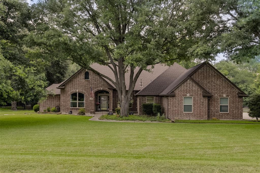Some homes impress you with square footage. Others impress you with how they live. Situated on more than an acre in one of North Waxahachie's most sought-after neighborhoods, this property offers the space, flexibility, & outdoor lifestyle that so many buyers are searching for. Mature shade trees, a welcoming approach, & a community pond create the kind of setting that feels established, peaceful, & increasingly difficult to find. Inside, the floor plan simply works. With 4 bedrooms, 2 living areas, & 2 dining spaces, there is room for everyone to spread out while still feeling connected. Whether you need a formal dining room, a home office, a playroom, a media space, or a second living area for multigenerational living, the flexible layout gives you options that adapt to your lifestyle. The standout feature is the kitchen. Spacious, beautifully updated, & designed for gathering, it offers abundant workspace, generous storage, & the kind of layout that naturally becomes the heart of the home. Whether you're hosting holiday dinners, helping with homework at the table, or entertaining friends, this is a space you'll actually use & enjoy. The primary suite provides a comfortable retreat, while the secondary bedrooms offer flexibility for family, guests, hobbies, or work-from-home needs.
Step outside & you'll discover what makes this property truly special. The oversized back porch invites you to slow down and enjoy the view of your yard, morning coffee, & evening sunsets. Amazing oversized garage that can fit a long bed truck or boat! Established trees provide shade, privacy, & character that can't be replicated overnight. An RV cover & dedicated parking add convenience for travelers, hobbyists, & outdoor enthusiasts alike. Located in desirable North Waxahachie, you'll enjoy the best of both worlds—room to breathe with convenient access to Waxahachie schools, shopping, dining, healthcare, & major commuter routes. This is the opportunity you've been waiting for!