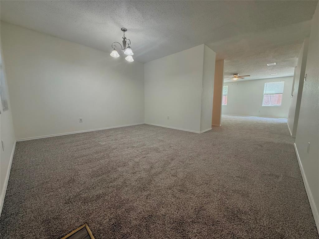 Fresh new carpet and updated photography give this spacious four bedroom home a fresh start. Priced to reflect its condition, this home offers an excellent opportunity for buyers looking for space, value, and the chance to make it their own over time. Whether you're buying your first home or simply looking for more room this thoughtfully designed floor plan offers four bedrooms, two and a half bathrooms, and a private first floor primary suite. Just off the entry, the flexible front room can easily serve as a home office, sitting room, playroom, or formal dining room to fit your lifestyle. The inviting living room features a wood burning fireplace and opens to the kitchen with a breakfast area for comfortable everyday living. Upstairs you'll find three additional bedrooms and a spacious game room that can serve as a media room, home office, playroom, or second living area. One of the home's standout features is the oversized backyard with plenty of room for entertaining, gardening, pets, play, or creating your own outdoor retreat. Move in today and personalize the home over time while building equity along the way. Conveniently located in the Justin area with quick access to Highway 114, I-35W, Texas Motor Speedway, Alliance Town Center, shopping, dining, and everyday conveniences. Located in highly sought after Northwest ISD. 30 minute drive to DFW International Airport. Some photos have been virtually staged to illustrate the home's potential.