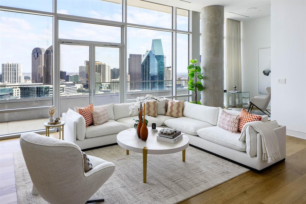 Located high above the city on the top floor of the iconic W Dallas – Victory, this custom-designed Penthouse offers a rare blend of modern glamour and effortless sophistication. Framed by dramatic downtown skyline views, the expansive private terrace becomes a true extension of the living space — perfect for sunset cocktails or intimate evenings overlooking the city lights.

Inside, soaring 13-foot ceilings and walls of glass create an airy, light-filled atmosphere. At the heart of the home, the open-concept chef’s kitchen pairs sleek design with exceptional functionality, showcasing elegant marble countertops and a full suite of premium Miele appliances. A built-in refrigerator, integrated wine cooler, gas cooktop, and dual ovens create a space equally suited for everyday living or elevated entertaining.

The thoughtfully imagined two-bedroom layout includes a separate office area, ideal for working in style. Designer finishes elevate every space, from the striking marble-surround fireplace anchoring the living room to the spa-inspired white marble baths. A massive custom closet delivers boutique-level storage, while every detail reflects elevated penthouse living.

Residents enjoy world-class Marriott hotel services including valet, concierge, onsite dining, spa services, state-of-the-art fitness center, and resort-style pool — delivering lock-and-leave convenience with uncompromising luxury.

A true statement residence in the sky.
