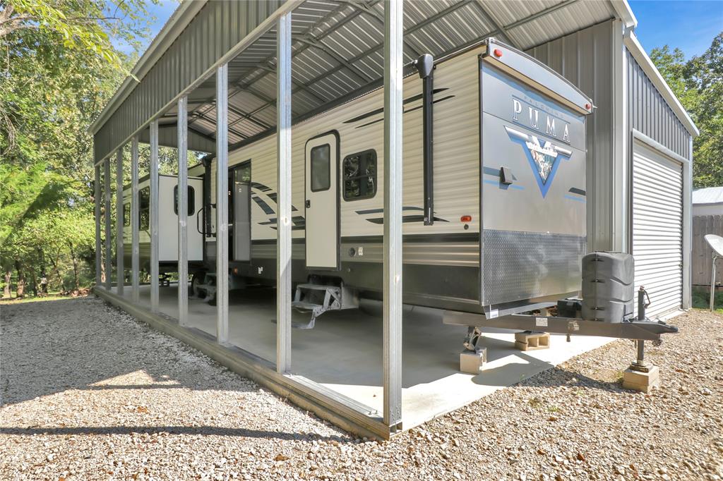 Escape to lake living at its finest on the famous Lake Fork with this immaculate 2021 38 ft Puma travel trailer featuring 4 slide-outs for maximum space and comfort. Set on a 30x40 concrete pad, this property combines the perfect blend of home-style living and outdoor retreat. Located in a gated community, this waterfront lot is surrounded by mature trees, wildlife and just a short walk to the lake from your backyard. Inside the homes spacious open layout you will find comfortable seating with 2 recliners, a pull out couch, a kitchen island, fireplace, abundant cabinets, SS appliances, never used stove-oven and stackable WD for convenience designed for full time living or weekend getaway.  
This property is turn-key, low maintenance, move in ready and perfect for enjoying lake life in comfort.
Holiday Village offers something for everyone, salt water pool, playgrounds, basketball courts, and putt putt golf. Stocked ponds, 2 boat ramps, onsite restaurant, monthly events, bingo, karaoke and much more. The lot can be purchased at $115k without the RV 
Family friendly neighborhood that is golf cart and ATV friendly. 
Mandatory HOA fee is $52 water and sewer are $65 monthly plus usage.  
Plenty of room for parking and a 14X30 garage for boat storage.