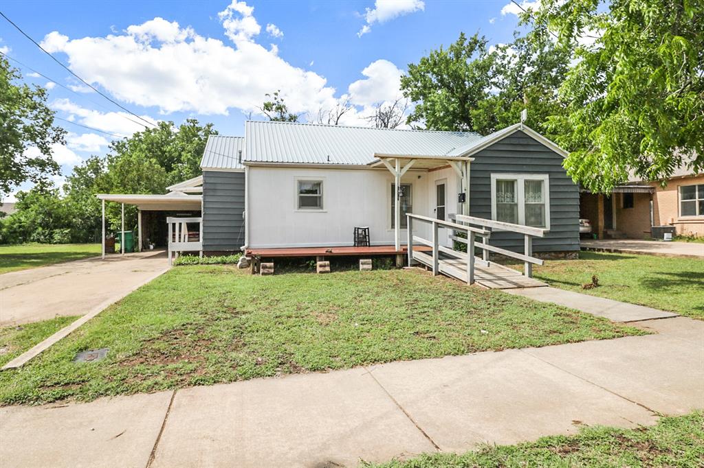 Charming 2-bedroom, 1-bathroom home on a spacious 0.3788 acre lot in Coleman. The living room features wood floors and abundant natural light from multiple windows. The kitchen includes a stand-alone gas oven, wood cabinetry, tile backsplash, recent paint, and refrigerator that conveys with the home. Nice-sized bedrooms with wood flooring offer comfort and privacy. The bathroom includes a tub-shower combo, updated vinyl flooring in 2024, vanity with sink, and a full-size washer and dryer area—appliances included. The home has a metal roof and a newly roofed covered front porch with metal decking. Accessibility ramps lead to both front and side entrances. Outside, you'll find a detached one-car carport and garage with electricity, as well as a wood-frame shed for extra storage. The large backyard includes tall trees and a vacant lot to the east for added space or potential development. The lot has separate utilities so building a workshop or second residence might be possible! This well-maintained property offers both comfort and opportunity in a fantastic location! Just a few blocks from the bustling downtown Coleman area, this property could also be used for a prime AirBNB house!