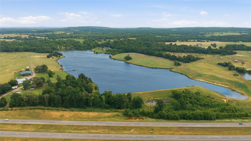 Nestled in the rolling countryside of Henderson County in LaRue, Texas, this exceptional 124± acre ranch offers the perfect blend of ranching, recreation, and East Texas beauty. The centerpiece of the property is an incredible 35-40 acre stocked lake with a spillage system, offering outstanding fishing with bass, crappie, and catfish along with breathtaking waterfront views.

Designed for both functionality and enjoyment, the ranch features cross-fencing, working pens, highway frontage along State Highway 175, and additional access from County Road 4343. The land offers a beautiful mix of open pasture and scattered woods, creating excellent grazing potential while providing wildlife habitat and recreational appeal.

The approximately 3,000 square foot barndominium features 4 bedrooms, 2.5 bathrooms, and an attached shop all under one roof, creating the ideal setup for country living and ranch operations. Utilities are already in place, making the property ready for immediate use and enjoyment.

Whether you’re looking for a working cattle ranch, premier fishing and hunting property, recreational retreat, or private waterfront estate, this rare East Texas ranch offers endless possibilities. Large private lakes of this size are incredibly hard to find, making this truly a one-of-a-kind opportunity.