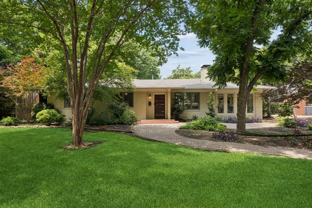 Great value on nearly half an acre in prestigious Forest Hills! Set on a rare 0.46-acre lot just minutes from White Rock Lake & the Dallas Arboretum and Botanical Garden, this inviting single-story ranch offers the perfect combination of updated living today & incredible upside for tomorrow.  Featuring 4 bedrooms, 3 baths, 2 spacious living areas & office, the home is designed for both comfortable everyday living & effortless entertaining. The beautifully remodeled kitchen is the heart of the home, showcasing a large island, premium range, abundant custom cabinetry & an inviting breakfast area. The dining room is wrapped in walls of windows, filling the home with natural light while overlooking the beautifully landscaped grounds. The private primary suite includes a peaceful study or sitting area, while updated bathrooms & light-filled living spaces create a warm, welcoming atmosphere throughout.  Step outside to your own retreat featuring a flagstone patio, sparkling pool with water features, expansive lawn, mature trees, & exceptional privacy. An electronic gate leads to a detached garage complete with a separate YOGA studio & half bath, ideal for a GYM.  While the home is move-in ready, it also presents an outstanding opportunity for a buyer to personalize & elevate the property over time. With Forest Hills lot values alone often exceeding $1.6M, this represents a compelling opportunity to secure one of East Dallas' most desirable addresses at an attractive price point.  Surrounded by winding streets, towering trees, & beautiful custom homes, Forest Hills offers a lifestyle unlike anywhere else in Dallas, with convenient access to White Rock Lake, the Dallas Arboretum, Lakewood Village, premier dining, shopping, & Downtown Dallas.