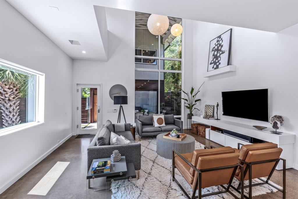 An architecturally striking contemporary residence just steps from Henderson Avenue’s premier dining, shopping, and nightlife. Now offered at $1,249,000, this home presents a rare opportunity to purchase below its recent $1.3M appraisal, allowing the next owner to step into over $50,000 in immediate equity from day one. Originally custom built by design professionals inspired by modern Japanese architecture, the residence blends thoughtful minimalism with warm, livable spaces. Expansive walls of glass flood the interiors with natural light, highlighting polished concrete floors, museum-finish walls, and elevated designer materials throughout. The open-concept layout centers around a chef’s kitchen with premium appliances, custom cabinetry, and an oversized island ideal for gathering and entertaining. Panoramic doors open seamlessly to the private outdoor retreat, where a heated pool, lush landscaping, and multiple lounge areas create a resort-like backyard experience. The primary suite offers a serene escape with spa-inspired finishes, while additional flexible living space can serve as a media room, office, or lounge. An oversized garage adds rare convenience for the neighborhood.