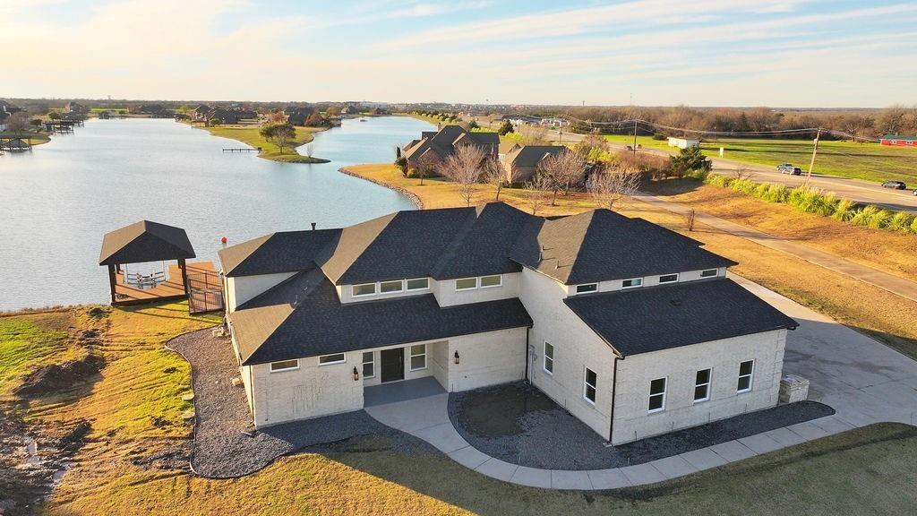 Welcome to a rare opportunity to own one of the most unique waterfront properties in North Texas, located within the exclusive Princeton Lakes private water-ski community. This isn't just a home—it's a lifestyle built around the water, relaxation, and unforgettable memories.
Imagine stepping into your backyard each morning and being greeted by calm, glass-like water, breathtaking sunsets, and the peaceful sounds of nature.

Whether you're an avid water skier, wakeboarder, boater, or simply someone who appreciates serenity.
Nestled on over an acre, this custom estate sits directly on a private ski lake that hosts professional water-ski training and competitions. Launch your boat from your private dock and covered lift, spend the day on the water, then unwind poolside while watching skiers glide across the lake from the comfort of your covered patio with automatic screens.

For boating enthusiasts, water-sports families, outdoor entertainers, and anyone seeking a private retreat from the city, this property offers a lifestyle few homes can match. The oversized four-car garage provides ample space for boats, recreational vehicles.

Inside, over $350,000 in renovations have transformed this home into a showcase of luxury and craftsmanship. Custom cabinetry, Italian porcelain flooring, quartzite countertops, marble accents, Viking appliances, floor-to-ceiling stacked stone fireplace, and stunning rear glass walls.
Energy-efficient features including geothermal heating and cooling, closed-cell foam insulation, and a newer roof help keep utility costs surprisingly low for a home of this caliber.

Outside, the heated self-cleaning pool and spa become your personal resort overlooking the water. Every day feels like a vacation.

Properties like this rarely become available. Whether you're a dedicated water-sports enthusiast, a luxury buyer seeking privacy and tranquility, or someone looking for a one-of-a-kind waterfront retreat that most people only dream about.