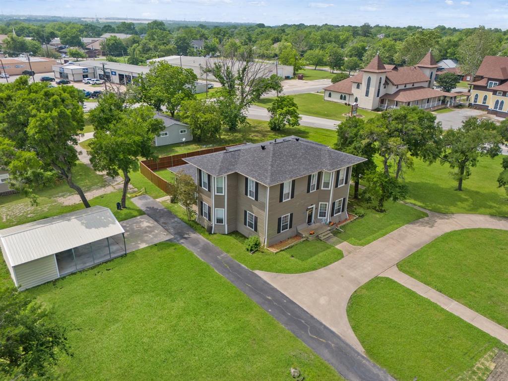 An opportunity to own a piece of Royse City History, commercial zoned nearly 1.3 acres in the Heritage District of Royse City right off of Main Street! The City has plans to extend Main Street just beyond this property and is Minutes from I-30. This is that largest lot off of Main Street... it is a wonderful opportunity for a Bed & Breakfast, Steak House, Doctors office, Attorneys office, etc. This incredible home features 5 (1 down, 4 up) enormous bedrooms, 3.5 gorgeous bathrooms, 3 Living Areas , all original wood floors throughout the original part of the home, stunning original woodwork up and downstairs, original transom windows, original stained glass, and pocket doors! NEW Gourmet Kitchen, Beautiful Dining area, over sized Laundry Room, newer waters heaters, New Plumbing and more. WALK to historic downtown to the craft brewery, boutiques, bakery, restaurants, and more! This home was built by WH Adams, a founding member of Royse City.