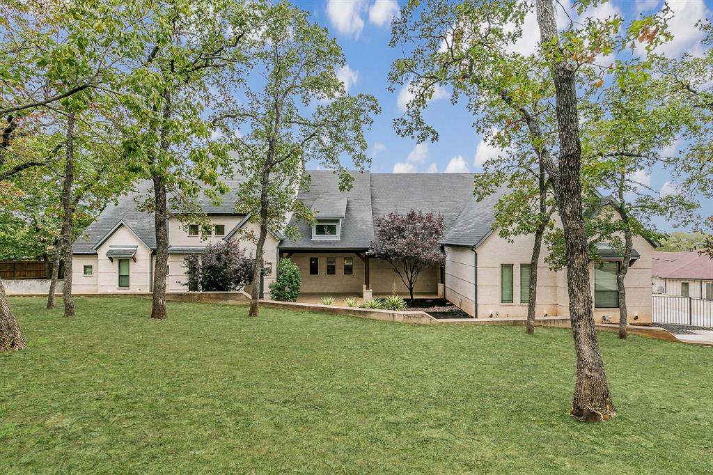 Welcome to your dream home nestled on a sprawling 1.2-acre lot, adorned with mature trees that offer both privacy and tranquility. This exquisite residence boasts a complete designer remodel  throughout the entire home.   The standout feature is the rare, fully enclosed mother-in-law suite. This private oasis includes its own living area, kitchenette, separate entry from the expansive 4-car garage, and a dedicated washer and dryer—ideal for guests or extended family living. The primary bedroom is a true retreat, occupying its own wing and featuring an additional room that can serve as a study or exercise space. Located in the desirable Southlake area of Denton County this home offers the benefit of lower property taxes and provides the flexibility to choose highly rated Southlake Carroll schools.  Experience the best of Southlake with added financial advantages and education options.  With walking distance to Marshall creek Ranch which offers equestrian and hiking trails.