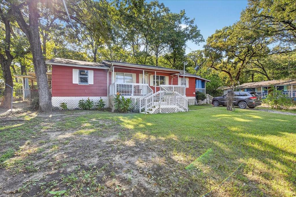 Charming home situated across the street from the lake on three  parcels, +or -  half an acre. Great opportunity for buyers willing to do some work, lots of potential, needs work, being sold as is.  The kitchen has been nicely updated with solid surface countertops, stainless style stove, microwave and updated cabinets.  Spacious add on living room at the back of the home features a stunning wall to wall fireplace, beautiful mantle, great focal point and tin on the ceiling. Split primary bedroom has an adorable covered patio, you will love it. Engineered wood flooring in the dining room, kitchen, hallway and living room. Enjoy multiple outdoor spaces, 3 patios total, in addition to the front porch, mature trees and plenty of room to make this property your own.  Wonderful above ground pool with decking and lots of trees and plants  to enjoy the hot Texas summers. With some TLC, this could be your retreat.   Buyer will need to buy a new survey, seller does not have one. Home being sold as is.  Financing fell through, please bring your cash buyers, lots of potential.  

Property to include Lots 25 and 26 Tanglewood Beach and lot 57 Tanglewood Beach 2 faces Bernie Dr