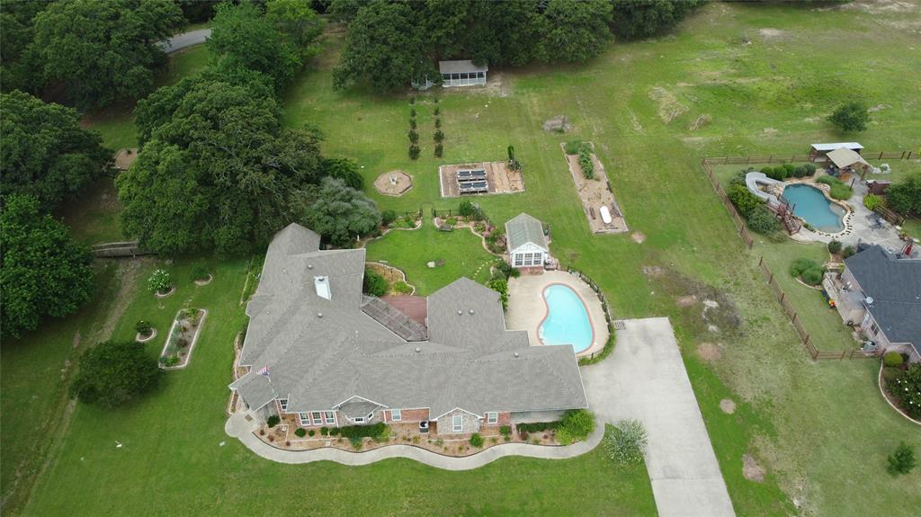 A one-of-a-kind property offering space, charm, and incredible outdoor living on a large corner lot this home has the flexibility to check all the boxes! Inside, you’ll find a spacious open-concept living area designed for both comfortable everyday living and effortless entertaining, with abundant natural light and seamless flow throughout the main gathering spaces. The fourth bedroom could be an office, a homeschool space or a craft room, and leads to a bright, cheerful sun porch. The den also has an adjacent sunroom! A highlight of this home is the abundant storage. Don't miss all of the large closets and a storage room right off of the laundry room! Step outside into your own private retreat featuring a sparkling pool, beautiful gazebo, and extensive established gardens that create a peaceful park-like setting. The greenhouse provides the perfect space for gardening enthusiasts, while the expansive yard offers endless opportunities for relaxing, entertaining, or cultivating your dream outdoor oasis.
Situated on an oversized corner lot, this property combines privacy, functionality, and unique character, all while offering plenty of room to enjoy both indoors and out. A rare opportunity to own a truly special home in one of the most desirable neighborhoods in Greenville.