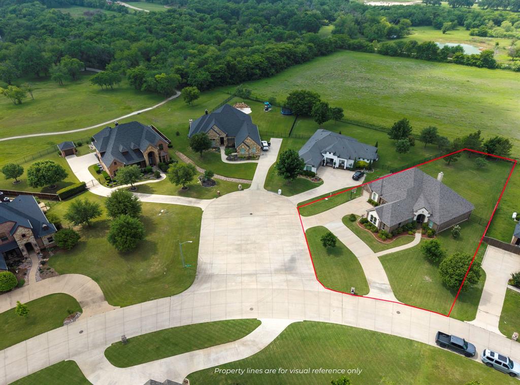 Backing to open farmland and situated on approximately half an acre in Prairie Timber Estates, this property offers the privacy, views, and breathing room that are becoming increasingly difficult to find. With no rear neighbors and only two side neighbors, the setting alone creates a sense of space rarely found in traditional subdivision living. Built in 2017, this home offers nearly 2,700 square feet of thoughtfully designed living space filled with natural light from abundant windows throughout. The living area is anchored by a stunning floor-to-ceiling stone fireplace, while crown molding, tray ceilings, and quality finishes add character and warmth throughout the home. The spacious primary suite was designed to stand out, featuring a unique oversized shower and soaking tub combination that creates a true retreat from the day-to-day. Step outside and you’ll quickly understand what makes this property special. The mostly covered 30x10 patio overlooks peaceful farmland beyond the backyard, creating the perfect place to enjoy morning coffee, evening sunsets, or gatherings with family and friends. The circular drive adds both convenience and curb appeal, while the additional toy garage provides valuable space for hobbies, recreational vehicles, storage, or equipment that most homes simply can’t accommodate.
Located in highly regarded Joshua ISD with convenient access to Chisholm Trail Parkway, this property offers a rare combination of neighborhood amenities, newer construction, usable outdoor space, and the privacy that many buyers are searching for but seldom find. Opportunities offering this blend of lot size, views, garage space, and location are becoming increasingly hard to come by.