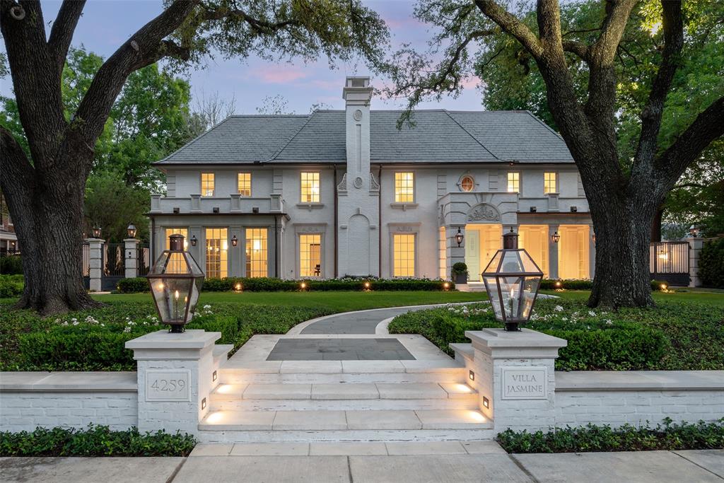Positioned on one of Highland Park’s most coveted and tranquil avenues, this exceptional property is among a select few with private access to a peaceful adjoining park. Designed with an indoor-outdoor living philosophy, this neoclassical estate connects light filled interiors with beautifully curated grounds. The architectural landscaping evokes the charm of a French country garden, featuring hand-cut stone, lush plantings, and an abundance of gas lanterns that create a warm, romantic ambiance.
Interiors showcase an extraordinary level of custom craftsmanship, including artisan millwork, lacquered finishes, imported marble fireplaces, hand-forged brass stair railings, antique mirror installations, and fully marble-clad mosaic bathrooms. A splendid 1 bedroom and 2 full bath guest house adds over 800 square feet of living space with all bespoke design features and an infrared sauna. The classic carriage house inspired garage offers state-of-the-art functionality with a single three-car-wide hydraulic door, accommodating six vehicles and additional space designed for a car lift. 
This historic residence has undergone a comprehensive renovation defined by an uncompromising commitment to quality in which every surface and system has been thoughtfully reimagined and executed to the highest standard possible. This is a rare opportunity to acquire a fully transformed Highland Park estate of architectural integrity, enduring value, and premier location.