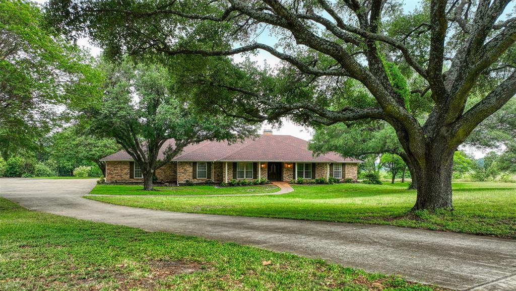Rare opportunity to own this beautiful home in one of Ennis’ most exclusive neighborhoods, situated on almost 3 acres! Designed with both comfort and entertaining in mind, this move-in ready home features 4 spacious bedrooms, 3 full bathrooms, 3 living areas, and 2 dining areas, offering plenty of room for everyone. The split-bedroom layout provides added privacy, while the multiple living spaces create flexibility for gatherings, relaxing, or working from home. The oversized utility room includes a built-in desk perfect for an office, craft space, or sewing area. A 3-car garage with a workbench provides ample parking and storage. Recent updates include roof replaced in 2023, fresh interior and exterior paint, and updated flooring throughout. Enjoy the perfect blend of space, functionality, and peaceful country-style living just minutes from town and Old City Lake!