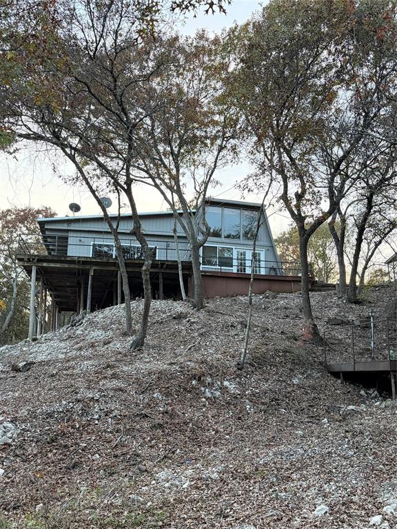 Adorable, quaint cabin priced right and ready for your personal touch! Relax on the large deck with a peek of the water, the abundant wildlife, from deer grazing in the yard to beautiful birds soaring overhead. Air conditioning was replaced in 2010. Minutes from the public boat ramp. Whether you're seeking a weekend getaway, a peaceful retreat, or a cozy year-round residence, this lakeside cabin is for you!