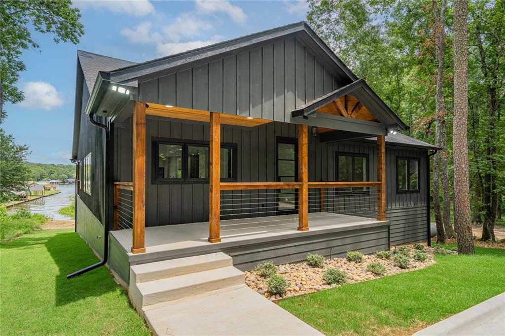 Welcome to 287 Naus Drive on beautiful Lake Cypress Springs! Finding a brand new build on this lake is extremely rare. This 2025, custom 4 bedroom, 3 bath home is thoughtfully designed with modern conveniences throughout, situated on a generous 1.93 acre lot with a BRAND NEW boat dock and serene lake views. Inside, you’ll find a spacious walk in kitchen featuring stunning granite island and counters, top of the line appliances, a walk in pantry with butcher block countertops, and upscale dual color cabinetry adding contract and sophistication. The living space features a modern wet bar offering a stylish touch for hosting, while the open layout flows effortlessly into a large walkout patio complete with a striking stone fireplace. Each bathroom is a showpiece, boasting designer tile combinations that elevate the overall aesthetic and add a custom flair to every space. The master suite is a private retreat, featuring expansive sliding glass doors that open directly to the patio, inviting in natural light and lake breezes. A HUGE bonus is the lake level flex room underneath the home with two garage doors making it ideal for a game room, bunk space, or a luxury storage for lake toys. A new retaining wall and boat house add long-term value, structural peace of mind and plenty of shoreline. Don't miss the opportunity to own this BRAND NEW, completely warrantied, exceptional full time residence or luxury weekend escape with it's very own Generac!