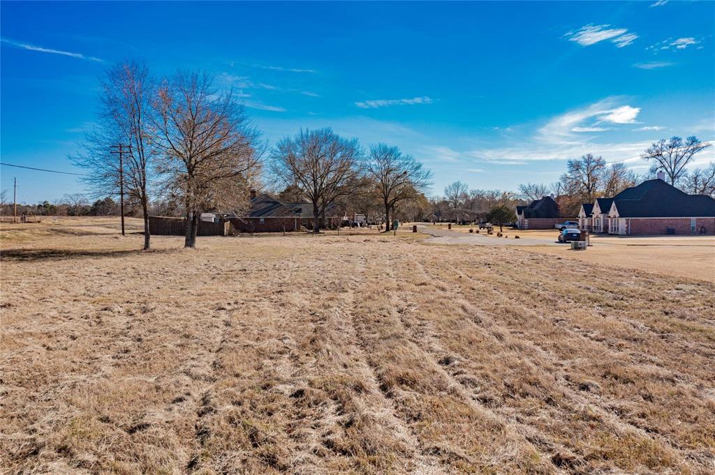 Come see this beautiful half-acre lot, ready for your dream home! Located in a deed-restricted area with minimum 1,400 SF of living space required. Homes must be constructed primarily of brick or stone. No mobile homes or barndominiums allowed. Utilities available include co-op water and Wood County Electric; aerobic septic system required. A great opportunity to build in a growing area with quality standards in place.