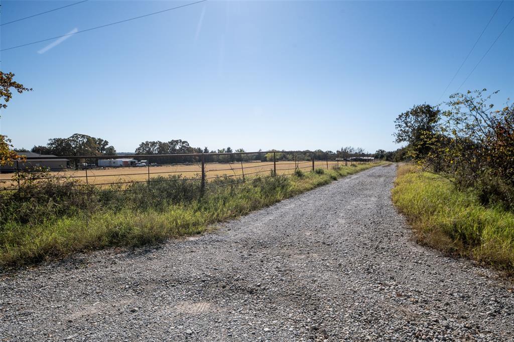 Discover the potential in this expansive 6-acre parcel of cleared, level land, perfect for building your dream home or a private retreat. This property boasts a rustic barn, some mature trees at the back for a natural privacy buffer, and the convenience of being just minutes from charming, historic Bowie, TX, which offers local amenities like restaurants, grocery stores, and a vibrant downtown with a variety of shops and boutiques. The generous acreage currently used as a hay field offers ample space for a workshop, animals, or a large garden. The area features a variety of properties, allowing new owners a chance to create their own vision. The large lot size offers a sense of privacy and separation, allowing you to focus on the possibilities this land provides. The level, cleared land provides potential building sites for a home, shop, pool, and much more.  Explore the local community and imagine the lifestyle you can build here. Seller is offering $10,000 in concessions.  There is a vacant mobile home on the property that was previously used as a rental property.  It has not been maintained for some time.  With a little TLC, the home could be used temporarily while building a new home. Please ask agent for details.