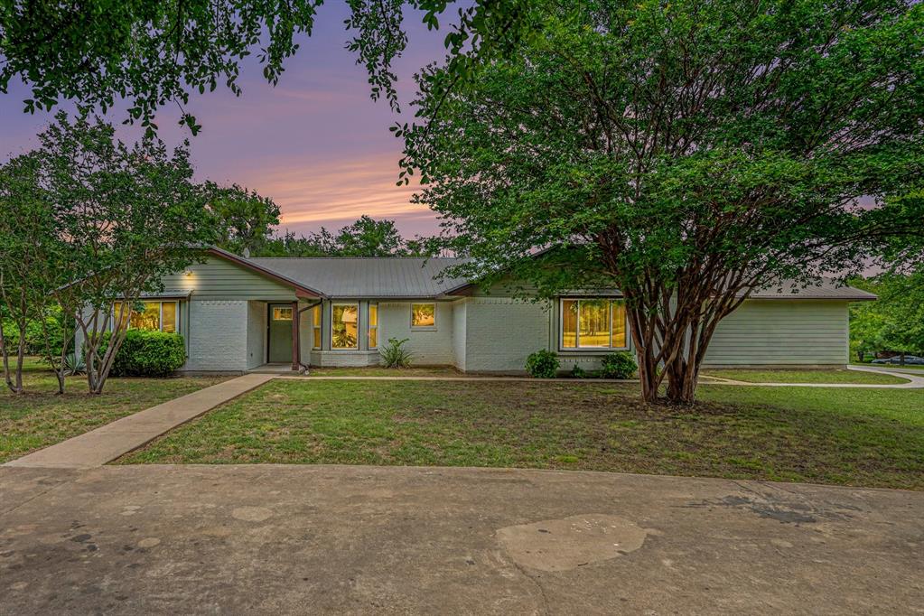 Welcome to 217 Kingswood Road—where small-town charm meets the highly sought-after Aledo ISD! Nestled on nearly an acre, this updated 3-bedroom, 2-bath home offers the perfect blend of space, comfort and convenience. Inside, you'll find vaulted ceilings, a cozy wood-burning fireplace, and an inviting floor plan designed for entertaining and everyday living. The spacious kitchen and living areas flow seamlessly, while beautiful, low E windows bring in abundant natural light - while also providing energy efficiency. Step outside to enjoy the oversized corner lot with circle drive, featuring mature trees, large covered patio, storage shed, 12x21 Mueller building, fenced dog run AND plenty of room for gardening, RV parking and outdoor living. The metal roof, 2-car garage, and no HOA add to this property's appeal. Located just minutes from shopping, dining, and easy access to I-20, 217 Kingswood offers the tranquility of country-style living with all the conveniences nearby. Rarely do homes with this much land, character, and location become available in Willow Park—don't miss your opportunity to make it yours!

Discounted rate options and no lender fee future refinancing may be available for qualified buyers of this home.