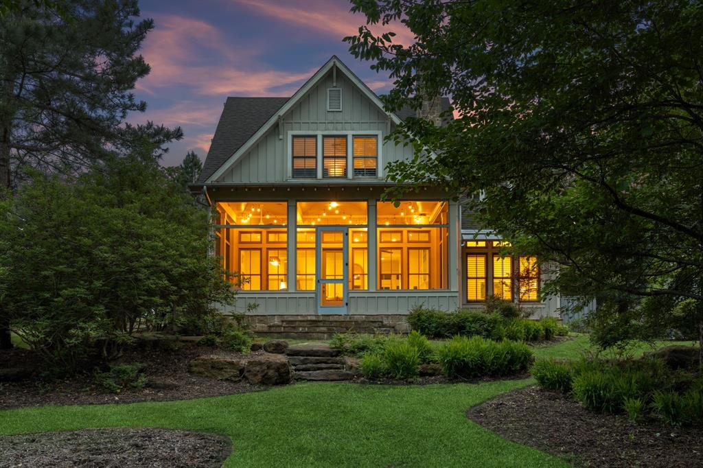 This lakefront Low Country Cottage is designed for comfort and flexibility, with both primary and secondary suites on the first floor for easy living and hosting. A spacious living area makes the gathering feel natural and opens to a screened porch for year-round use. The kitchen is supported by a sizeable pantry and ice maker, while updated tile finishes add a refined touch. Upstairs offers a flexible layout for additional living or sleeping space. Set in a wooded area that blends with a spectacular lake view, the home offers privacy, and a strong sense of care, all just a short walk from the Lake Club, Play Field, and Future 15-Hole short course designed by Beau Welling.
