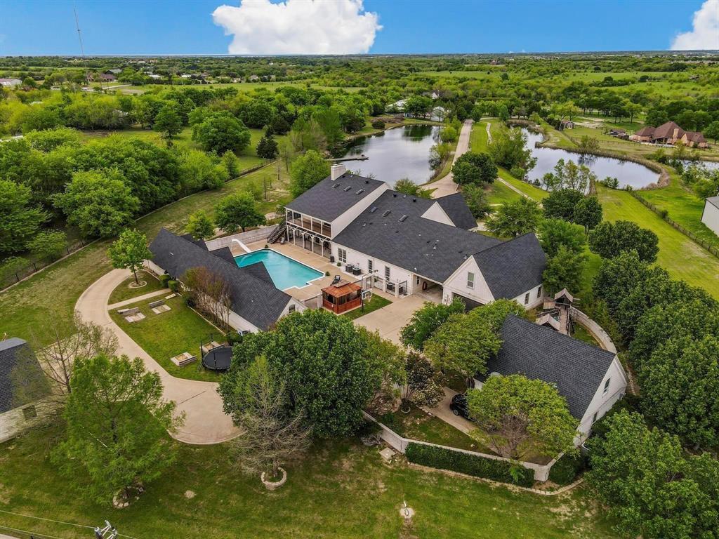 Virtual tour online this Magnificent luxury Estate, privacy, with nature. put you initials on the Private electric gate enjoy the scenic drive to your new home as you pass 2 large stocked ponds. Main home delivers with 4 bed, 3 full, a half bath, Office, 2 living and 3 dining areas. Spacious kitchen with granite, breakfast bar, double oven. Master retreat with sitting area, ensuite bath has soaking tub, walk in shower, dual vanities and dual closets. 2nd floor impresses with a spectacular large living room with cathedral ceilings, wet bar, 2nd fireplace, long balcony with private stairs overlooking the pool, outdoor living on both floors. pool house. 2nd floor completes with 2 bed, full bath, Media Cinema Room, Children's  retreat, and game room. Pool House has large living area, bath, bedroom and kitchenette with a large room on 2nd floor. Outside you find Cabana, spa, covered outdoor living with gas fire pit, entertaining, and dining areas for relaxing by pool. Guest home has 3 bed living room, kitchen, mbedroom, bath, on the 1st fl and 2 bed up. So much space.