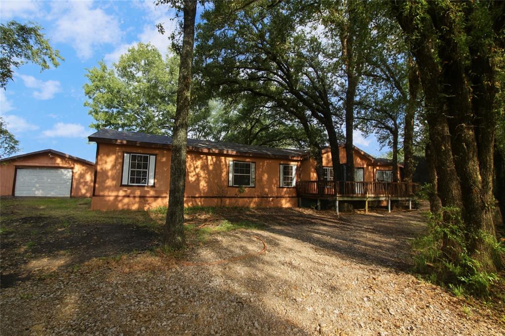 Spacious 6-Bedroom 3 Bath Home on 1 Acre in Timarron Estates – Crandall ISD!  Welcome to country living with room for everyone! Situated on a full acre of land in desirable Timarron Estates, this 6-bedroom, 3-bath home offers endless possibilities for large families or those who just need extra space. Built in 2003 and offering 2,128 square feet, the home features a comfortable open layout that begins with a generous living room leading into the kitchen and dining area. The kitchen includes a center island and plenty of cabinet space — the seller is willing to install a stove prior to closing!
Four of the bedrooms and two full baths are tucked on one side of the home, creating a perfect setup for kids or guests, while the spacious primary suite and adjoining flex room or office (used as a 6th bedroom) are privately located on the other. The primary bath includes dual vanities, a large soaking tub, a separate shower, and a huge walk-in closet.  Outside, enjoy mature shade trees, open yard space ideal for playsets or backyard barbecues, and a 20x20 detached building that’s been divided into two rooms perfect for storage, a home gym, or a workshop.  With Crandall ISD schools, space to spread out, and a peaceful setting just minutes from town, this home is your chance to make a country escape your own!