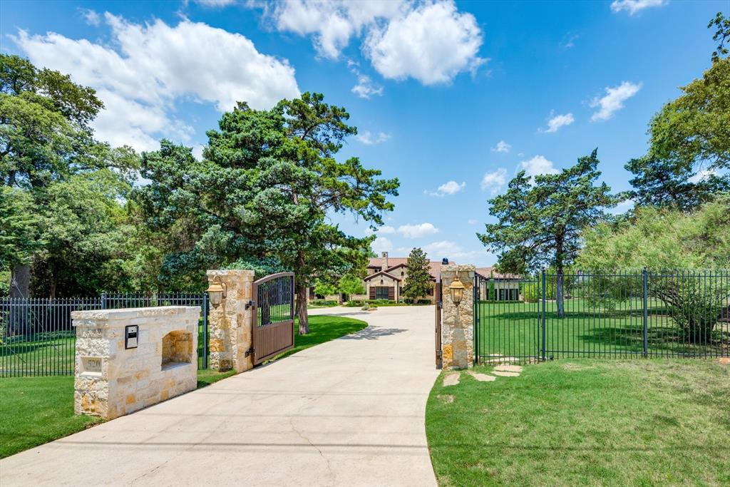 UNIQUE opportunity! A ONE STORY custom-built estate on 1.33 acres in the heart of Southlake! Perfectly sited to maximize privacy, views of grounds & large salt water pool. Bkyard has outdoor kitchen, firepit, pool bathroom w shower & SEPARATE building with half court GYM for everyday workouts! Floorplan designed for easy entertaining with great flow from the front living & dining room thru to the Family Room open to amazing Kitchen. Huge island, multi refrigerators & 3 dishwashers, large pantry & tons of cabinets. Down the hall to the fantastic Theatre Room, THEN a game room with two TVs & 3 ensuite bedrooms & study nook. Secluded & spacious Primary suite, copper soaking tub, custom closet cabinets. Private Guest suite with views of the entry courtyard. Executive study with raised-panel mill work and storage. Planning office and IN-HOUSE workout room. Tankless Hot Water. Easy access to 114, Town Square and CISD schools.*** NOTE Approx 1400+ sq ft GYM NOT INCLD WITH HOUSE SQ FOOTAGE***