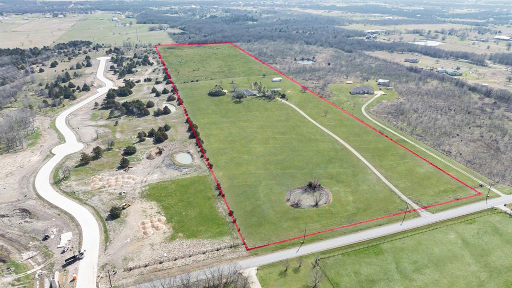 Outstanding opportunity on coveted Munson Road minutes from Rockwall-Lake Hubbard and Royse City! This sprawling 25-acre lot estate offers unparalleled peace, quiet, and room to roam. Adjacent to the new Munson Ranch development and it's also a great opportunity for a developer! Ideal for 2–5 acre homesites, acreage lot subdivision, residential community, or long-term investment hold in a high-growth area! The rolling, partly treed with two small ponds offer privacy, beauty and true country style living! The house was constructed in 1998 with 3 bedrooms and 2 baths. On the back of the house, you will find a 20x20 shop and a smaller storage building. This property provides the perfect blend of location, infrastructure, and opportunity.