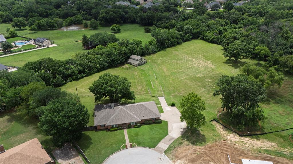 A tremendous opportunity to own almost 5 acres to build your estate in Carroll ISD.  House is very original, and is livable, but value is in the land.  Picturesque views of the pasture, and bordered by Little Bear Creek! Tax assessor is incorrect- house is over 2,700 square feet, and land is just over 4.8 acres according to the owner.  Very old survey is available, but a new survey would be highly encouraged.   Checking on deed restrictions, which should be minimal. New construction going up on the lot next door.