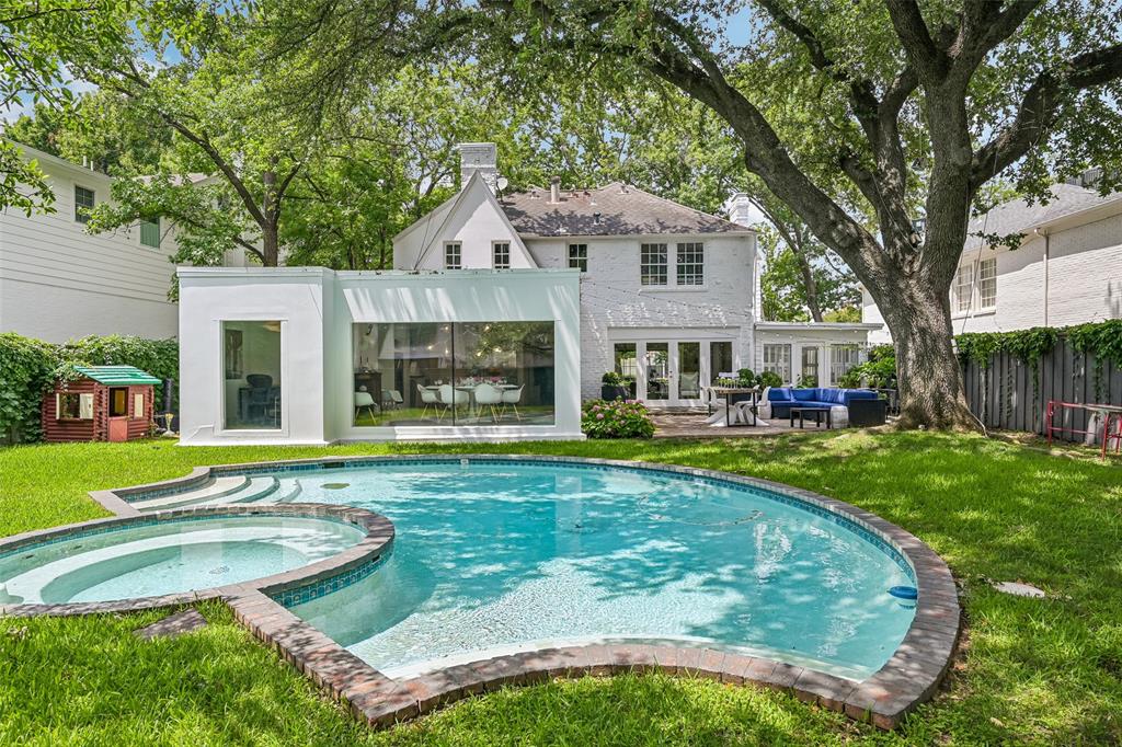 Timeless Highland Park charmer situated on a 60 x 139 lot in the coveted, tree-lined French Streets. Filled with natural light, this inviting home offers an open and versatile floor plan with a stunning wall of windows overlooking the backyard and pool. The first floor features a gracious entry, elegant library with gas fireplace, a chef’s kitchen with adjoining dining area, a spacious living room with seamless access to the outdoor patio, a charming sunroom, and a private office. A shared full-size laundry and walk-in pantry, a half-bath with marble flooring, and an unfinished pool bath complete the lower level. Upstairs, the private primary suite is accompanied by two secondary bedrooms connected by a Jack-and-Jill bath. The expansive backyard is designed for entertaining with a large patio, sparkling pool, and generous grassy lawn. Ideally located near Flippen Park and Highland Park Village, and zoned to Bradfield Elementary.