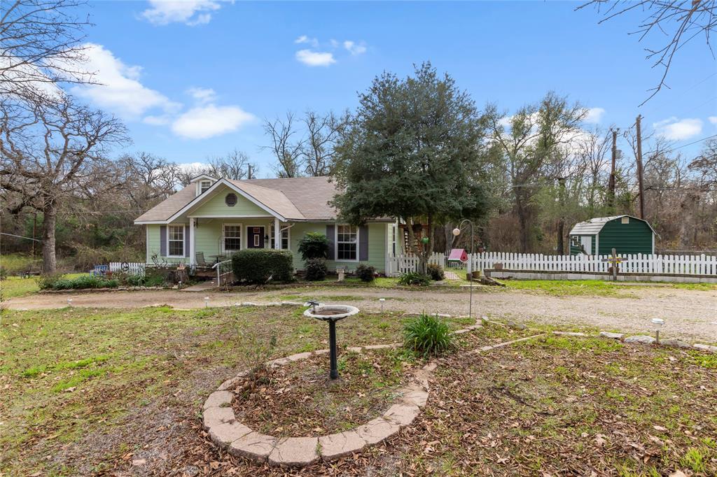 Quaint 3 bedroom 2.5 bath with 1,316 Sq.ft on two lots just a short walk to the lake. Ready for your updates this is a perfect starter home or rental property! This home features partial lake views and RV hookups. The circle drive creates easy access and plenty of space for parking. The white picket fence creates a cozy backyard setting for evenings with friends and family on the wooden back deck. Attached outdoor stairs leading to unfinished private room is the perfect space for an office or craft room! New low maintenance Hardie board siding & double pane windows. Handicap accessible ramp leading into the home.