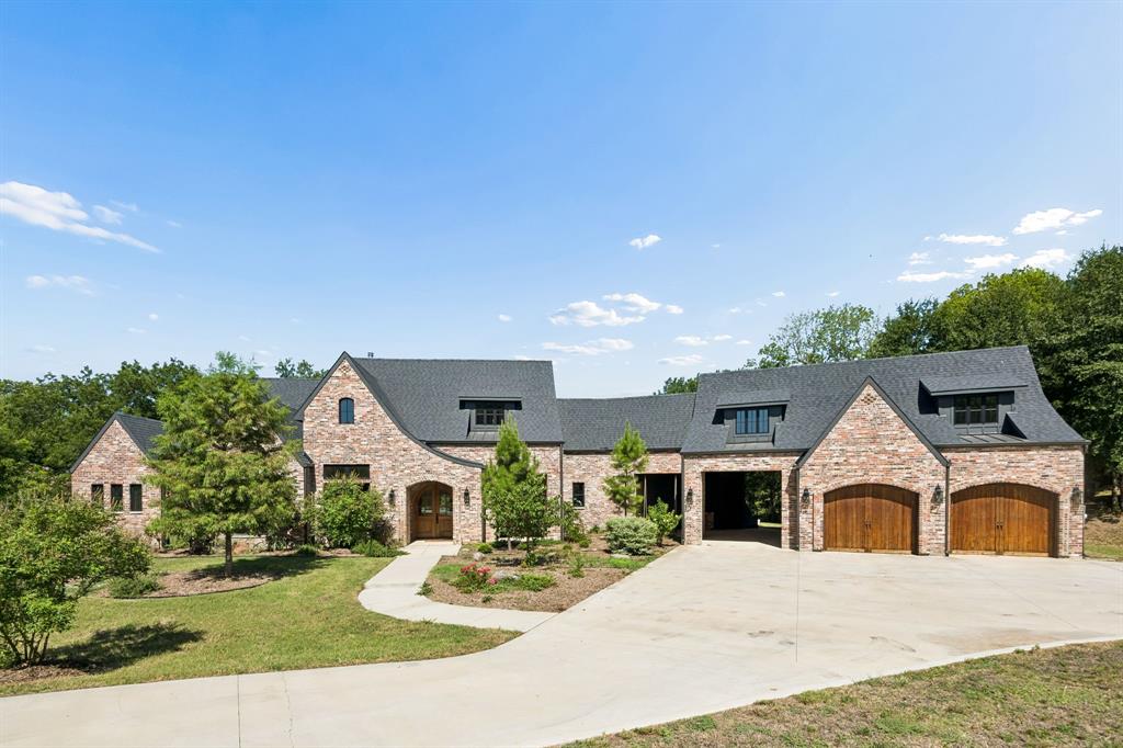 Nestled on approximately 40 breathtaking acres of rolling hills in Bristol, Texas, 468 Andrews Road is a custom-built estate where luxury and country living come together. Surrounded by mature oak trees, open pasture, and scenic views, this approximately 4,350-square-foot home offers exceptional craftsmanship and thoughtful design throughout.

The open-concept floor plan features expansive windows overlooking the property, seamlessly connecting the living, dining, and kitchen areas. The chef's kitchen is complemented by a spacious butler's pantry with abundant storage, an additional sink, refrigerator, dishwasher, and a secure safe room.

The private primary suite offers incredible views, a large walk-in closet with direct laundry room access, and an adjoining flex room ideal for an office, sitting area, or nursery. A dedicated office is located near the main living space, while the opposite wing features four additional bedrooms, two full baths, a second living area, and unique loft spaces above each bedroom.

Outdoor living is designed for entertaining with a covered patio, stone fireplace, and outdoor kitchen overlooking the ranch. A porte cochere leads to the attached two-car garage, with approximately 400 square feet of climate-controlled bonus space above, perfect for a guest suite, studio, or game room.

The property is cross-fenced for livestock with approximately 15 acres of improved pasture and the balance in beautiful hardwoods, offering the perfect blend of open grazing and wooded privacy. Additional improvements include a shop-barn and outdoor theater area.

From the moment you enter the gated drive, you'll appreciate the peaceful setting, exceptional privacy, and timeless quality of this remarkable Texas estate.