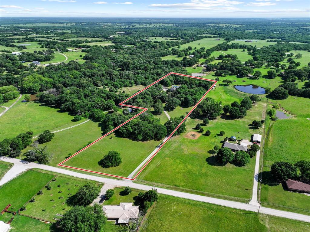***Per sellers, Magnus Rd and Devoignes Rd are set to be paved in June 2026. Welcome to the home that truly has it all—set on approximately 6.34 acres in Denison and introduced by a beautiful, tree-lined driveway that creates an immediate sense of privacy and arrival. This well-maintained ranch-style home offers over 3,500 square feet with 3 bedrooms, 2.5 baths, and multiple living spaces including a spacious family room, dedicated dining area, and a light-filled sunroom.

The oversized primary suite serves as a true retreat with plenty of room to unwind. Interior features include ceramic tile flooring, a wood-burning fireplace, and generously sized rooms throughout.

Outdoors, enjoy your own private oasis with an in-ground pool, expansive patio, and a stunning pergola—perfect for entertaining or relaxing under the shade of mature trees.

A standout feature is the fully equipped shop with heating and cooling and a 220V plug, ideal for projects, hobbies, or business use. The acreage provides endless opportunities for animals, recreation, or future improvements.

Enjoy the peace of country living without sacrificing convenience—located just approximately 11 minutes from the infamous City Limits restaurant and 14 minutes from Walmart, Target, and Cinemark and other chain restaurants.