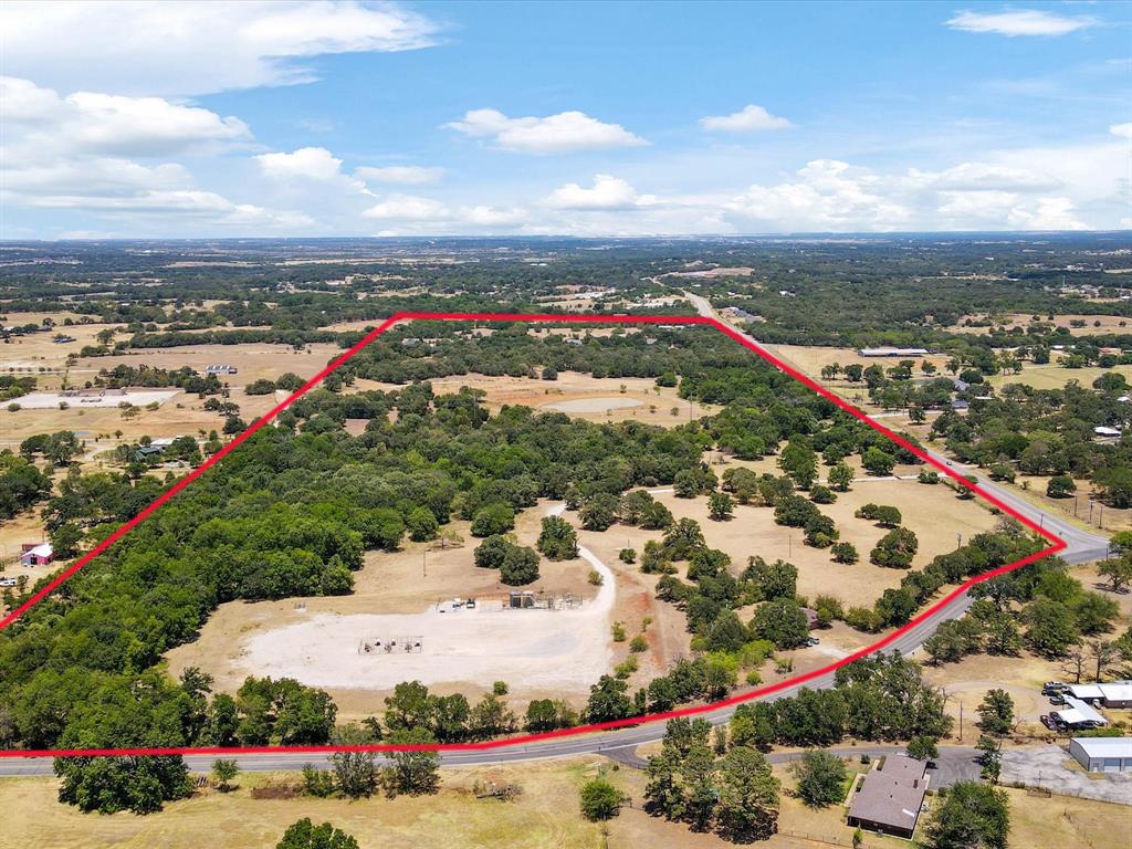 69.123 acres located on the corner of FM 731 (John Jones Drive) and FM 917 (Conveyor Drive).  This land is in a rapidly growing area of Johnson County with close proximity to Interstate 35 and Highway 174.  The property has mature trees, a large stock tank, and lots of road frontage.  This would make a beautiful residential development but also has commercial potential.  This property is located in the ETJ of Burleson and is located in Joshua ISD.  The home and one acre are included and no value has been given to the house.  Buyer to confirm availability of utilities.