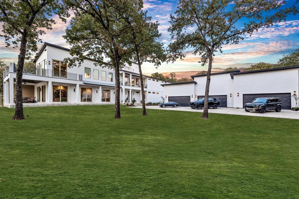 Enjoy lavish, lake-front living on this 4.5-acre Lakewood Village custom-built estate on Lake Lewisville.  Soak in the spectacular 180-degree views, spend your time fishing & boating, and take advantage of all the activities that lake life offers.  This home has it all - floor-to-ceiling windows throughout, kitchen with multiple islands, wine fridge, gas range, gun room with wet bar, private office(s), hidden doors with key-phab security, a large indoor basketball court with custom slam ball trampoline, oversized weight room, a billiard game room, and a movie theater.  The 1600 sq ft garage can hold all your toys with room for 9+ cars(one with elevated roof height for lift), boats, jet skis, and so much more.  This stunning property is a must-see and perfect for that person or family who wants everything.   One of the prettiest and best lots on the lake.