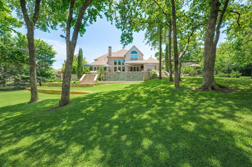 SEARCH YOUTUBE FOR HD VIDEO OF THIS HOME! AVAILABLE FOR IMMEDIATE MOVE IN & CAN BE SOLD VIRTUALLY FULLY FURNISHED with an acceptable offer! Custom STEEL & GLASS FRONT DOORS welcome you into your new home! DUAL curved staircases! GOURMET KITCHEN with a 48 inch built-in fridge, 36 inch Pro-Style Gas Cooktop, CUSTOM CABINTERY that runs all the way to the ceiling & a HUGE pantry! Single level kitchen island with breakfast bar seating!  Don't miss the amazing wet bar with bar height seating, kegerator, under-counter ice maker, sink & upper glass display cabinets! Also not to miss is the step-down WINE GROTTO with room temperature storage & DAUL-ZONE under-counter wine fridge! DUAL FRONT FACING OFFICES! Or if desired, convert 1 of the offices to be used as a 6th bedroom! Don't miss the stunning & private views from the 1600 SQ FT of outdoor living space anchored by 2 CLAFFEY POOLS... the upper 7' deep INFINITY POOL that spills over into the lower 4' deep PLAY POOL! PROFESSIONAL LANDSCAPE & TREE LIGHTING will expanding your living space into the evenings! The HUGE rear facing downstairs primary suite offers DUAL owner's closets, a 6' jetted tub & custom shower w-DUAL shower heads! It also offers lockable cabinetry to keep your most important treasures protected. Also downstairs is a very unique feature.... a MOTHER-IN-LAW SUITE that not only boasts a bedroom AND a full bathroom, but it also has its own private LIVING AREA! This area just off the kitchen could be converted to be used as a home gym, a downstairs media room, or a playroom for young kiddos! Upstairs each of the 3 bedrooms offer their own en suites, so each guest or family member will have their own privacy!  Also upstairs is a HUGE GAME ROOM with ceilings that rise high and a custom barn door to help quiet things down when needed! This home also boasts a 3 CAR GARAGE with CUSTOM FLOORING & CABINETRY!  The ceilings in the garage are 10' high, so a car lifts could be added to allow more vehicles! Welcome home!