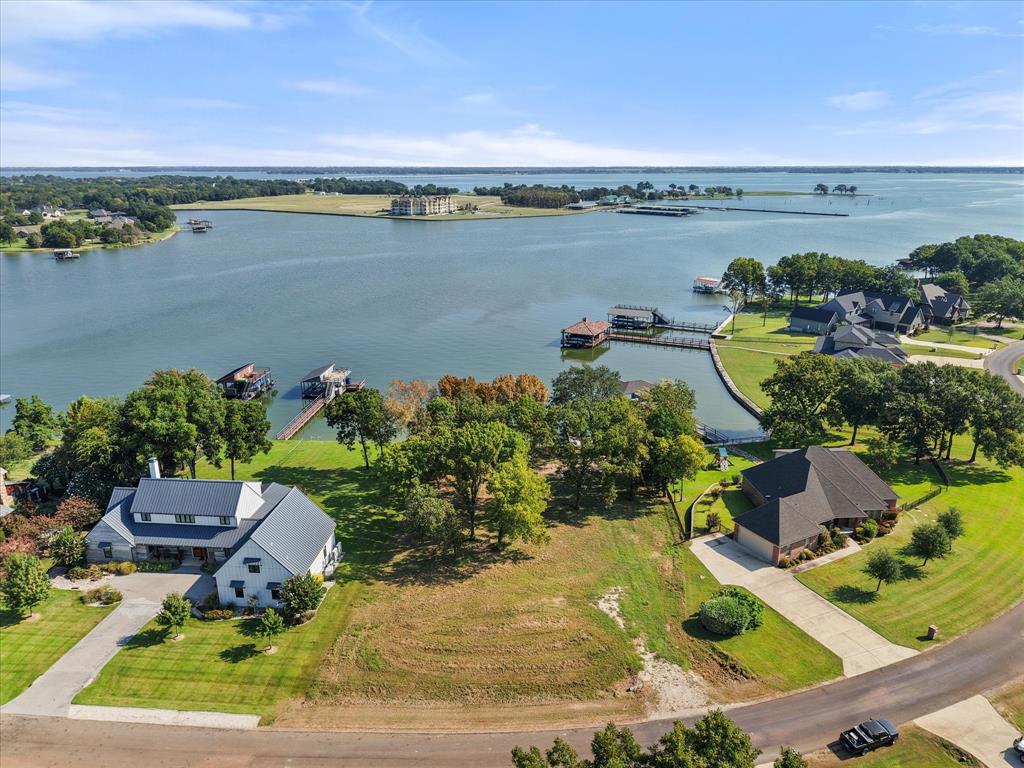 Discover this fantastic setting on beautiful Richland Chambers Lake. This lot is situated on the picturesque peninsula in The Shores community, located on the inlet side. This is prime property for your custom built home. Breathtaking waterfront with retaining wall in place, along with wooden dock. This gated community as much to offer including a boat ramp, clubhouse that features a pool and a fitness center, and a private stocked fishing pond. Welcome to both luxury and serenity.