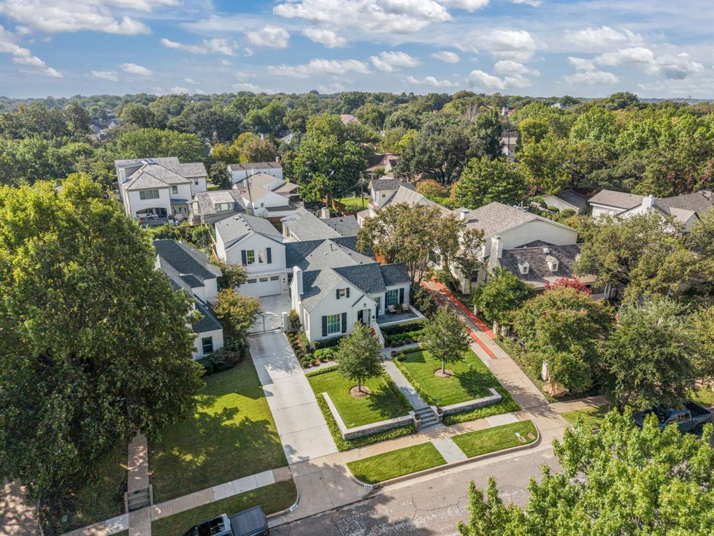 Perfectly situated in the heart of Fort Worth’s premier neighborhood, Monticello, this home has been completely reimagined & rebuilt to perfection. Now offering 5 bedrooms, 5 baths, multiple living areas, dual utility rooms, wet bars, & an elegant 1st floor study (opt. 5th bedrm), all complemented by an attached 425 sqft. garage—every inch of this home was designed with luxury & livability in mind. Step through into a bright, inviting formal living space that flows seamlessly into a chef’s dream kitchen. Outfitted with top-of-the-line appliances, including a La Cornue range, second oven, & built-in cabinets, this culinary space features a stunning island with seating, an adjacent dining area, & a full butler’s pantry with additional storage & prep space. Continuing through the first level of the home, you’ll find three bedrooms with three full bathrooms & a spacious second living area that anchors the main level—perfect for daily living, entertaining guests, or relaxing with family. The grand primary suite is a showpiece—floor-to-ceiling windows, a cozy fireplace, & a boutique-style walk-in closet she’ll love, plus two additional closets for him. The spa-like primary bath defines luxury with heated tile floors, dual vanities, a walk-in shower, freestanding soaking tub, & a private utility room with washer, dryer, built-ins, & a third sink for added convenience. Upstairs, discover two additional bedrooms & a spacious shared bath with dual sinks, perfect for family or guests. Step outside to your private resort-style retreat—a designer pool with deck jets, outdoor shower, & a fully equipped outdoor kitchen featuring Wolf appliances, built-in cabinets, dishwasher, refrigerator & freezer drawers, & a stunning stone outdoor fireplace. Motorized mesh screens allow you to enclose the patio & a Generac whole-home generator ensures uninterrupted comfort & convenience. No detail was overlooked & no expense spared in crafting this one-of-a-kind Monticello masterpiece.