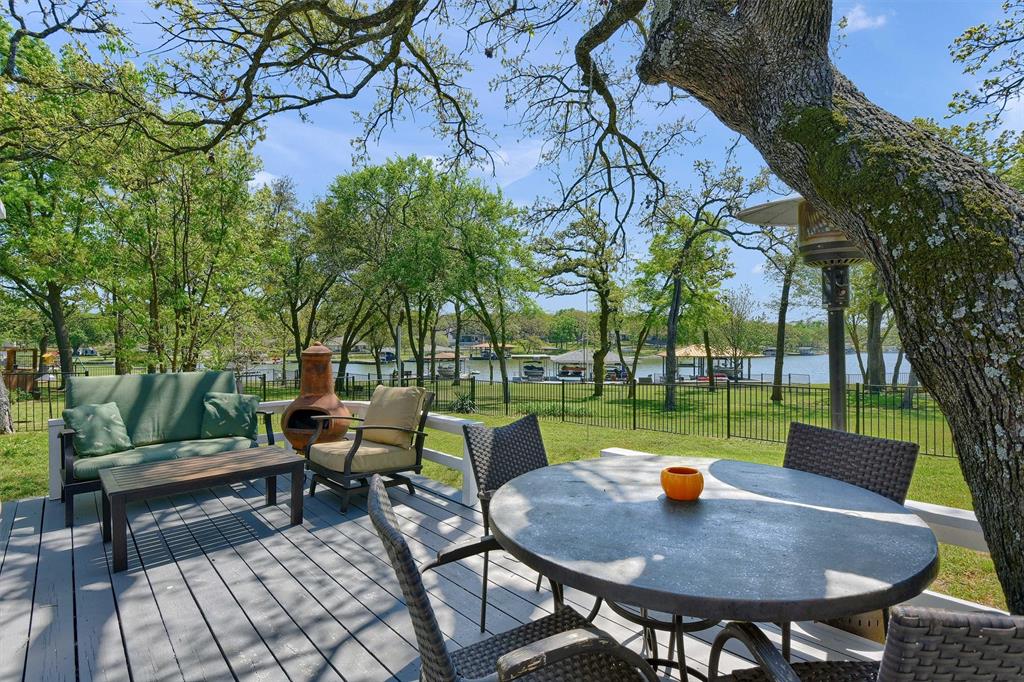 Welcome to your fully furnished lakefront retreat, offering a thoughtful blend of comfort and functionality—an ideal escape for relaxation and recreation. Located on the northeast shores of beautiful Lake Kiowa, this property features four bedrooms, two bathrooms, and a separate guest quarters complete with an additional bedroom and one-and-a-half bathrooms, providing ample space for family and guests. The spacious kitchen, living, and dining areas are highlighted by natural wood vaulted ceilings, an expansive kitchen island, and a wood-burning fireplace. The open-concept layout seamlessly connects the main living spaces, maximizing functionality while creating an inviting environment for entertaining and gathering. Outdoors, enjoy a covered deck and an additional lower deck overlooking the yard and scenic lake views. The home offers common-access lakefront ownership and includes one boat-lift dock, the far right lift when facing the docks from the house. Recent updates include new carpet throughout and a new hot water heater.
