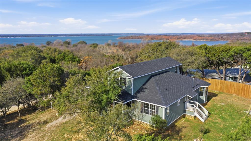 Owner financing available. Welcome to Paradise Point. This fully renovated 2,622 sq. ft. lake-view home offers  4 bedrooms and 3.5 bathrooms with a bright, luxurious open layout built for both comfortable living and entertaining.The upper level features a versatile space that works perfectly as a second living area or game room, positioned to capture stunning views of Lake Whitney. Major updates have already been completed, including two new HVAC systems, updated plumbing and electrical, a brand-new roof, and spray foam insulation in the attic, between levels, and beneath the lower floor for strong energy efficiency. Situated on nearly half an acre and directly across the street from Corps of Engineers land, this property offers convenient access to the outdoors while remaining just minutes from the lake. Whether you’re looking for a full-time residence, weekend escape, or investment opportunity, the flexibility is there.vIf you’ve been looking for space, views, and a move-in-ready home near one of Texas’ premier lakes, Paradise Point deserves a closer look.