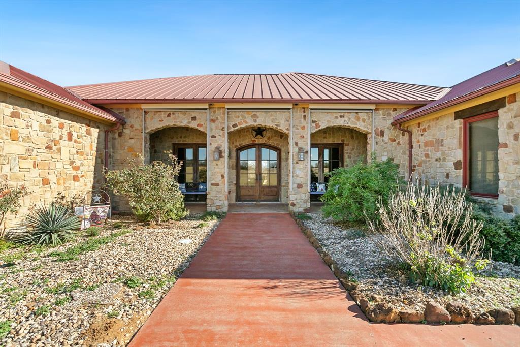 Tucked behind a peaceful landscape of open pastures and mature wooded surroundings, this extraordinary 91-acre private estate offers rare seclusion, elegance, and escape. Designed for those who value refined living with room to breathe, this remarkable property blends luxury, privacy, and versatility into a setting that feels both grand and deeply personal.

The 4,255 sq ft main residence showcases timeless design and elevated craftsmanship. Soaring wood-beamed ceilings, rich stone accents, and expansive windows create warmth and quiet sophistication while framing serene views. A dramatic stone fireplace anchors the living space, setting the tone for refined yet relaxed living. The chef’s kitchen features premium Viking appliances, custom cabinetry, and an oversized island ideal for entertaining or everyday living.

A separate 1,200 sq ft guest house provides a private retreat for family or guests. Beyond the homes, the estate unfolds into a curated mix of open coastal hay fields and wooded acreage, creating a peaceful, park-like setting. A 3-stall horse barn with tack room supports personal equestrian use, while a separate metal shop offers exceptional flexibility with a game room, workout room, and additional garage bays.

Resort-style outdoor living completes the experience with a sunken swimming pool for sunny afternoons and a firepit for evenings under the stars. Every element is designed to encourage relaxation, connection, and enjoyment of the natural surroundings. This is more than a home — it’s a private retreat and legacy property defined by space, serenity, and understated luxury.