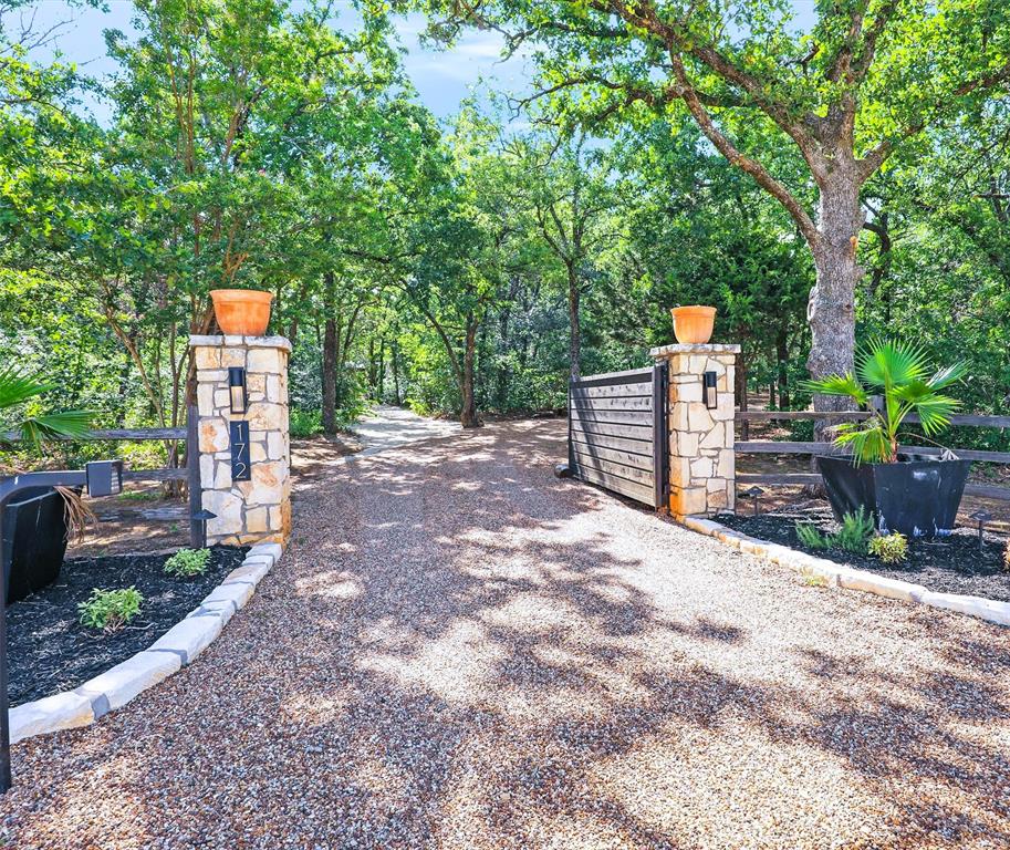 Amazing value! This 5+ acre wooded estate is a haven of rest & retreat! Minutes to DFW Airport, Argyle ISD. Designed to enjoy nature with soaring walls of steel windows & exterior-swing doors that bring the feel of outdoors in! Superior architecture & floorplan combines leisure & functionality. Located in Denton Co. in an ETJ in the city of Bartonville, no city taxes, no HOA and offers extraordinary uses with 6 multi-use living & dining spaces, lg. commercial kitchen, 7 !suites with en-suite baths. Owner's suite has private living space, office, sauna, fireplace & a private entry & view to the resort style setting & wooded forest backdrop with swimming pool-spa, outdoor shower, picnic areas, outdoor kitchen, multiple patios & pavilion style areas, guest quarters and a HVAC gym-sized area with epoxy floor - ideal for a health fitness area, event area or show-garage complete with EV connection. Property has been redesigned & completely renovated for today’s family, in-home on-site business owners, in-home education, and multi-generational living. If you're looking for a floor plan that offer flexible use of spaces, IDEAL for entertaining, in a setting that offer peace and tranquility yet minutes from the acclaimed Argyle ISD, private schools, shopping, and dining, you must see this incredible home and property!