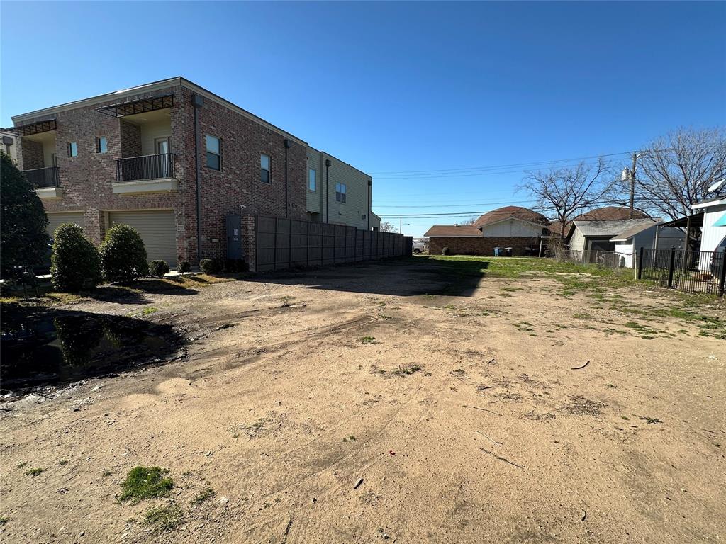 Vacant lot in Dallas is a clear parcel of land situated in an area experiencing significant new construction. Zoned for single-family residence, the lot is devoid of any existing structures and cleared. Next to newer constructed duplexes reflecting the ongoing development in the area.