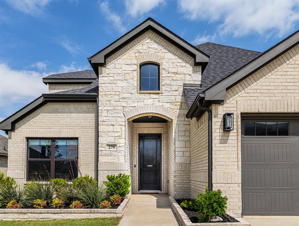 Welcome home to 279 Moonshadow Dr in Waxahachie, TX where a RARE 2.75 percent ASSUMABLE loan provides massive MONTHLY SAVINGS for qualified buyers  This beautiful 2-story traditional brick and stone home blends TIMELESS COMFORT with MODERN LUXURY, offering 3 SPACIOUS bedrooms, 2.5 baths, and 2,500 square feet of bright, airy living space. Tucked away in the PEACEFUL Buffalo Ridge neighborhood, this 2020-built property provides the PERFECT BACKDROP for creating lifelong family memories. SOARING 10-Foot Ceilings Elevate the entire main floor, complete with RICH WOOD FLOORING and STUNNING 8-foot doors, alongside  a GOURMET CHEF'S KITCHEN showcasing PREMIUM granite countertops, a walk-in pantry, rich cabinetry, and a COZY DINING NOOK sized for an 8-foot table. The Master Suite offers an EXPANSIVE first-floor sanctuary paired with a luxury SPA BATHROOM featuring a garden soaking tub, dual vanities, and a CUSTOM RAIN SHOWER. A dedicated home office is TASTEFULLY positioned downstairs with large windows to create a peaceful, light-filled workspace. The upstairs GAME ROOM is prepped for a ceiling-mounted projector, creating the ultimate setup for family movie nights. Packed with ENERGY EFFICIENT EXTRAS, including a TANKLESS water heater, DEEP 12-inch attic insulation, and smart thermostat technology MAKES LIVING COMFORTABLE & CONVENIENT. Outside you'll find a beautifully LANDSCAPED YARD featuring masonry-edged garden beds and three mature trees providing a private, secure green space. Out back, the deep COVERED PATIO spans the entire length of the main living area, offering a PRIVATE OASIS for morning coffee or sunset barbecues. The LOW STRESS HOA offers full use of community facilities, and the neighborhood provides QUICK ACCESS to Highway 287, local parks, and the HISTORIC CHARM of downtown Waxahachie. Zoned for HIGHLY REGARDED Waxahachie ISD Schools, this exceptional property is ready to wrap you in comfort from the moment you step through the front door!