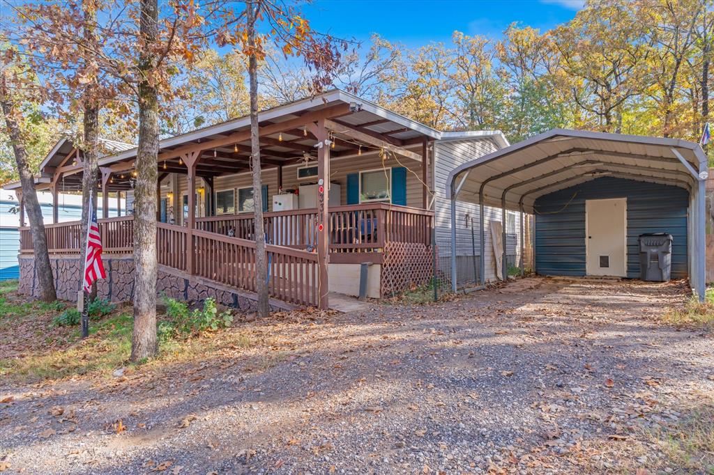 New Price! Tucked inside the sought-after Mallard Cove community, this property offers the kind of lake lifestyle people come to Lake Fork for, but rarely find with this much space. Just a short walk to the water, you’ll enjoy access to a private community boat ramp, making early morning fishing trips and sunset cruises as easy as they should be. Situated on four spacious lots totaling approximately 1.5 acres, this property gives you room to breathe. Whether you’re parking boats, adding a shop, or simply enjoying wide-open outdoor space, the possibilities here are wide open. The large covered deck is the kind of spot you’ll find yourself using every day, morning coffee with peaceful lake views through the trees, and evenings spent unwinding while deer and wildlife pass through. The home features 3 bedrooms and 2 full bathrooms with a comfortable, functional layout that works equally well for full-time living or weekend escapes. All improvements were completed in 2017 when the home was placed on the property, offering peace of mind and a cohesive setup. Outside, the property is dialed in for lake life. You’ll find an RV cover, boat cover, and multiple storage buildings, perfect for keeping all your fishing gear, tools, and equipment organized and protected. Whether you’re looking for a full-time residence, a weekend retreat, or a dedicated fisherman’s getaway, this one checks the boxes. Enjoy quiet surroundings, room to expand, and quick access to the legendary largemouth bass fishing that makes Lake Fork a destination. Buyer to purchase new survey. The home is situated on lots 42 and 43. Lots 44 and 45 are each .34 acres and can be sold separately or together. Call agent for details.